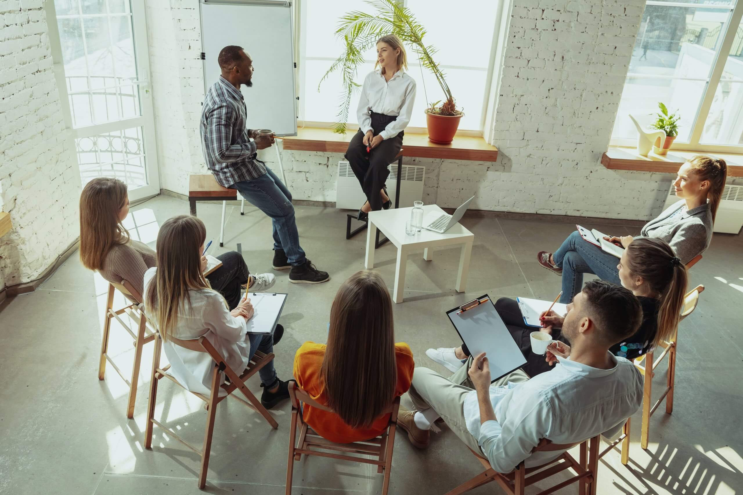 consultant-running-a-small-workshop-with-a-team-of-employees-scaled (1).jpg